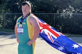 man wears Australian flag as cape