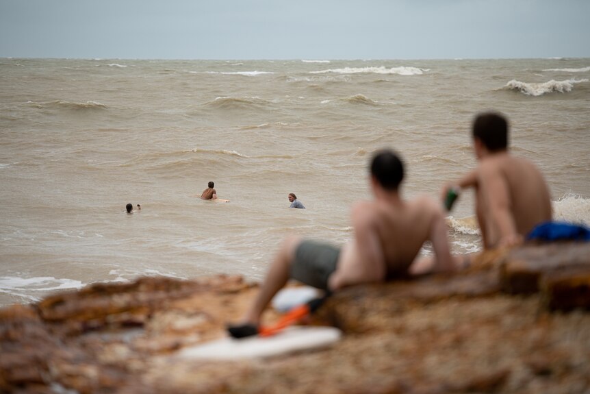 Onlookers watching heavy swell in the ocean at the Nightcliff foreshore. 