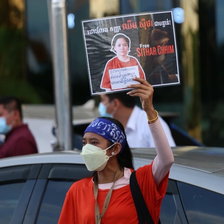 A protester holds up a poster.