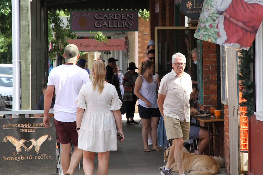 People walking down a busy street in Bright.