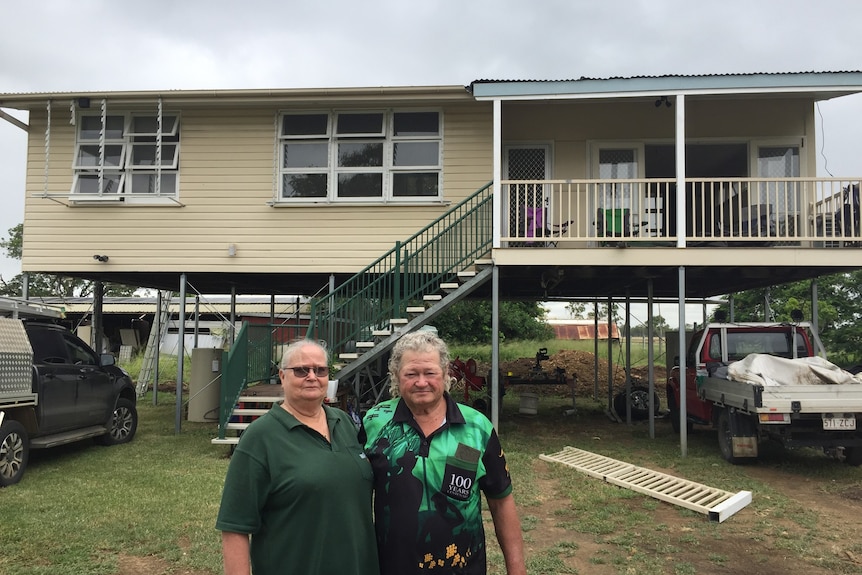 An older couple outside their new relocated home near Rockhampton. 
