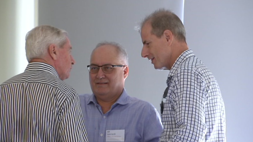Alf Leonardi chats with former Chief Minister Paul Henderson at a conference.