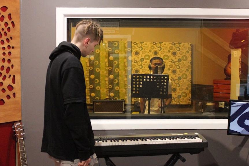 Two young men in a music studio