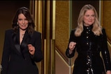 Tina Fey and Amy Poehler on a split screen, making it appear they are at the same venue.
