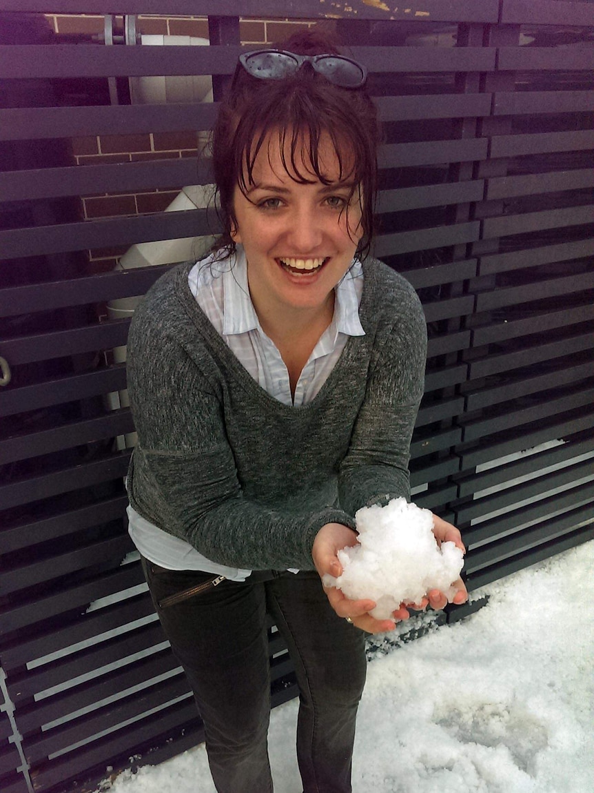 Maddy Galea holds a handful of hail