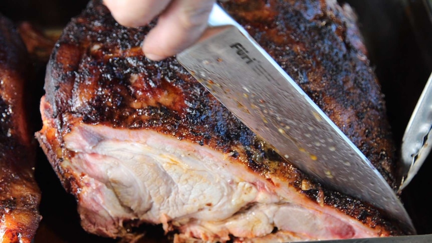 Pork being cut at BBQ competition