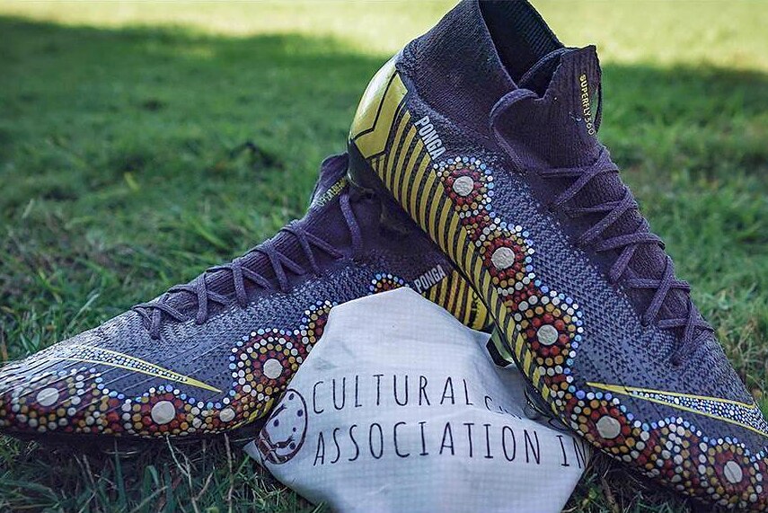 Close up of football boots painted with Indigenous art.