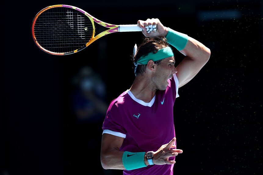 A male Spanish tennis player plays a forehand during the Australian Open.