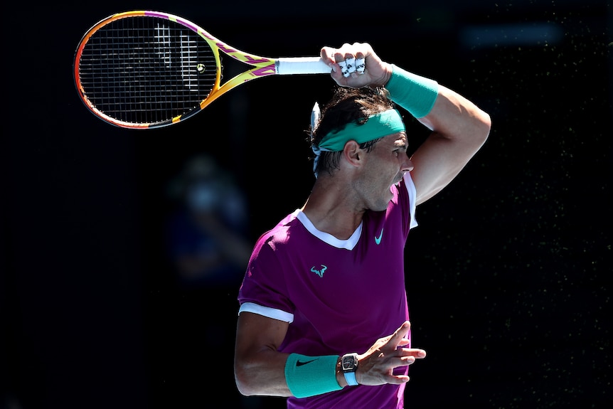 A male Spanish tennis player plays a forehand during the Australian Open.