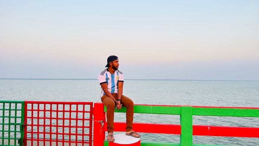 Samsul Alam sitting on the banks of the Naf River. 