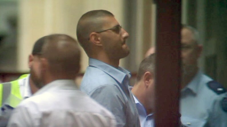Joseph Esmaili is led from the prison van and into court.