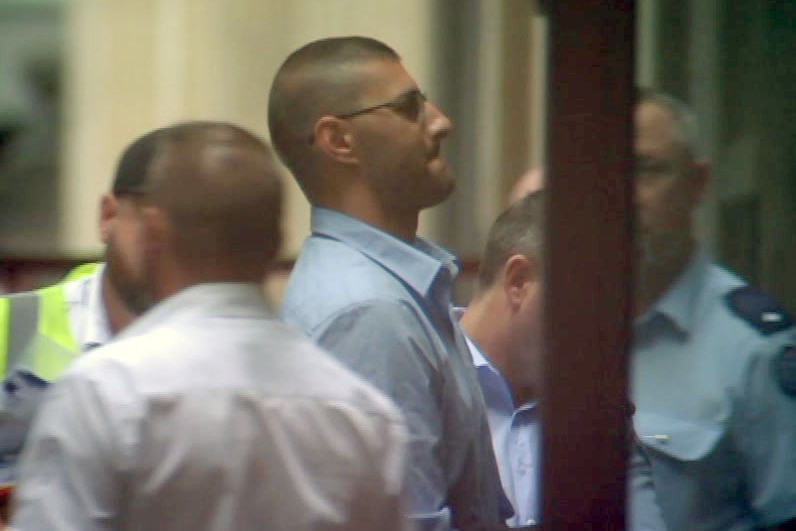Joseph Esmaili is led from the prison van and into court.