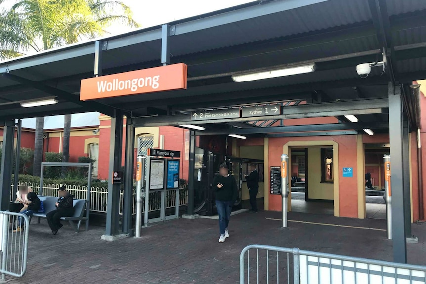 Wollongong train station in the afternoon, with commuters waiting.