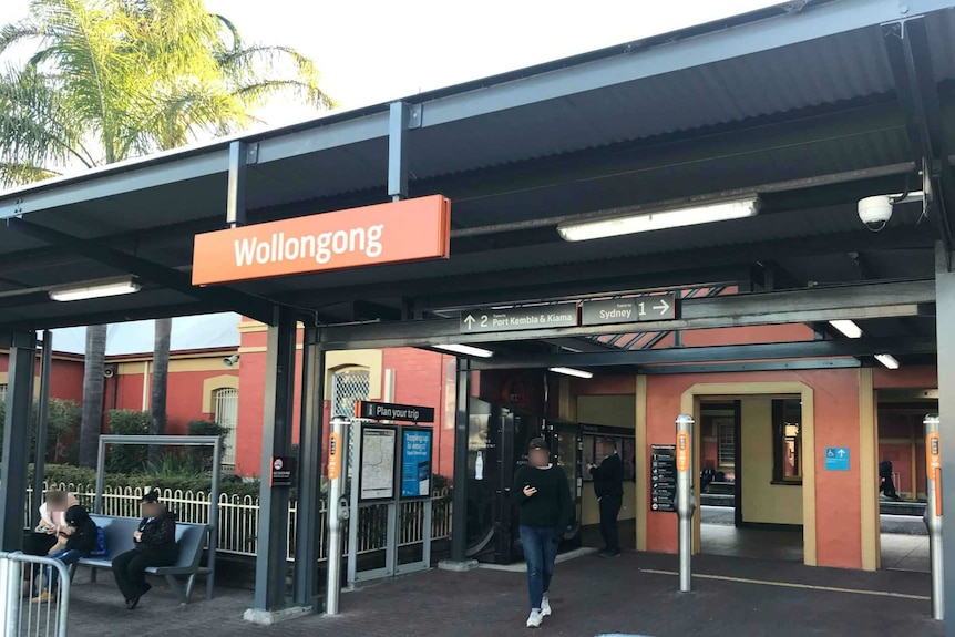 Wollongong train station in the afternoon, with commuters waiting.