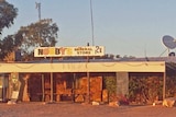 The general store at Mintabie in a dusty landscape.