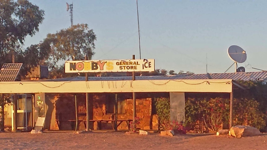 Nobby's general store at Mintabie in a dusty landscape.