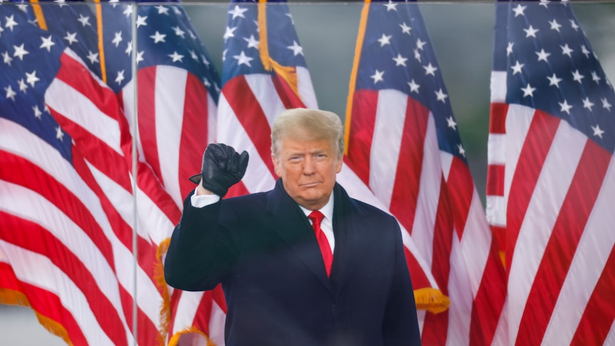 US President Donald Trump raises his fist as he speaks at a rally on January 6, 2021.