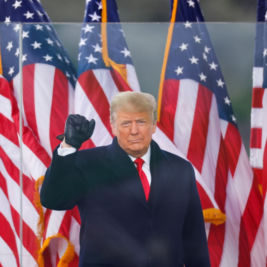 US President Donald Trump raises his fist as he speaks at a rally on January 6, 2021.