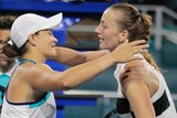 Ashleigh Barty smiles as she hugs Petra Kvitova at the net at the Miami Open.