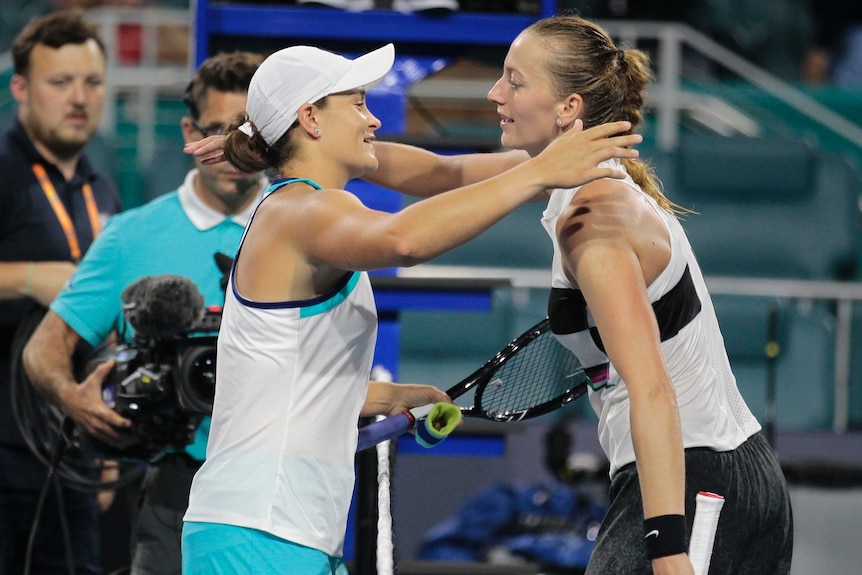 Ashleigh Barty smiles as she hugs Petra Kvitova at the net at the Miami Open.