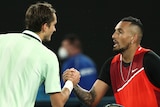 Two male tennis players shake hands at the net at the Australian Open.