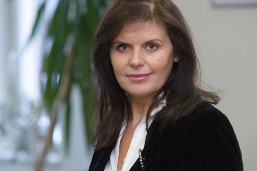 Head-and-shoulders portrait of woman in business attire.