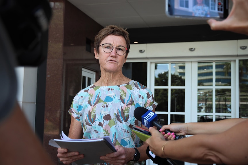 A woman stands outside court speaking.