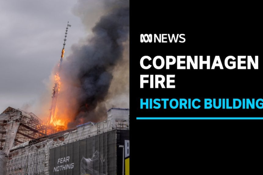 Copenhagen Fire, Historic Building: Flames and smoke billow out of a building covered in scaffolding. 