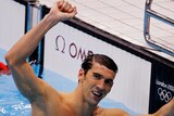 Michael Phelps of the US celebrates winning gold in the men's 100m butterfly.