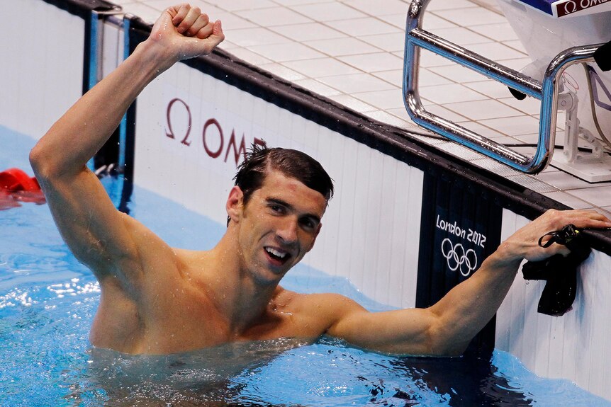 Michael Phelps of the US celebrates winning gold in the men's 100m butterfly.