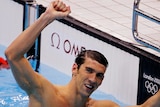 Michael Phelps of the US celebrates winning gold in the men's 100m butterfly.