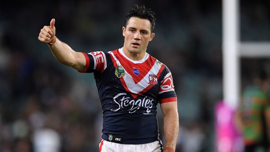 Cooper Cronk gives the thumbs up with his right arm, while his left hangs by his side.