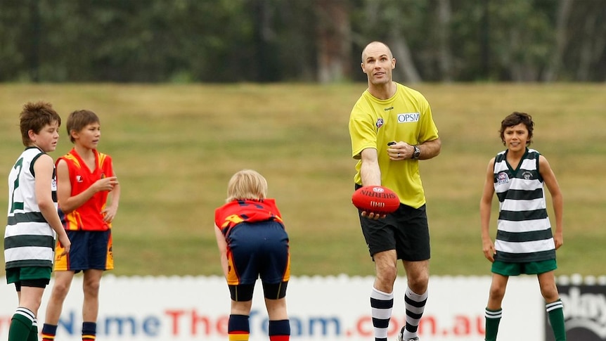 Big kid: Two time Geelong premiership-winning captain Tom Harley throws the ball up