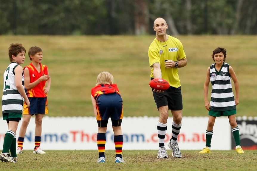 Big kid: Two time Geelong premiership-winning captain Tom Harley throws the ball up