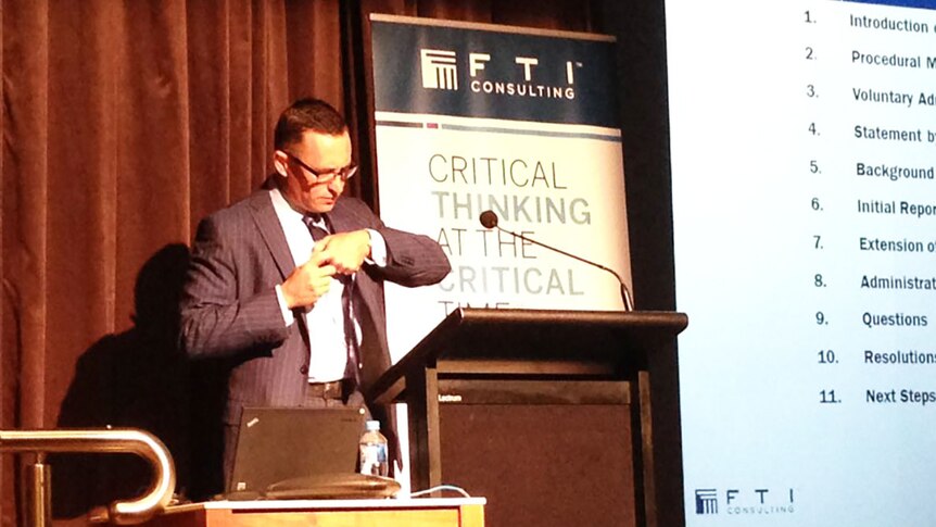 FTI consulting administrator John Roe at a podium preparing to address Queensland Nickel creditors