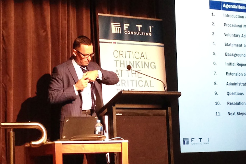 FTI consulting administrator John Roe at a podium preparing to address Queensland Nickel creditors