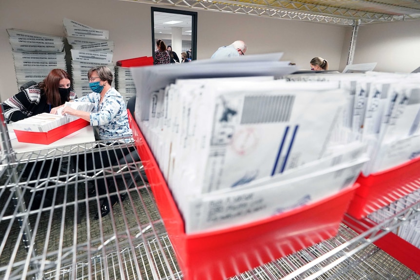 US election officials count ballots out of red boxes