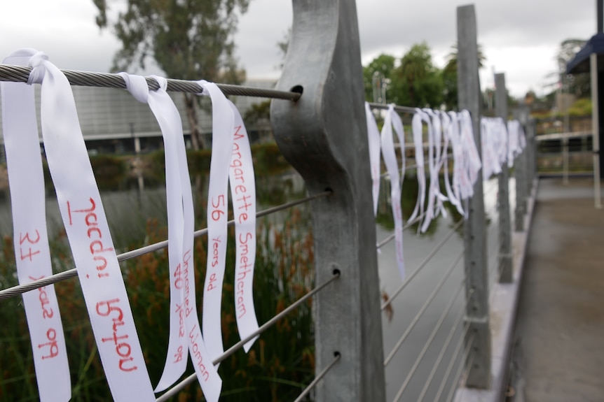 Ribbons tied to a fence.