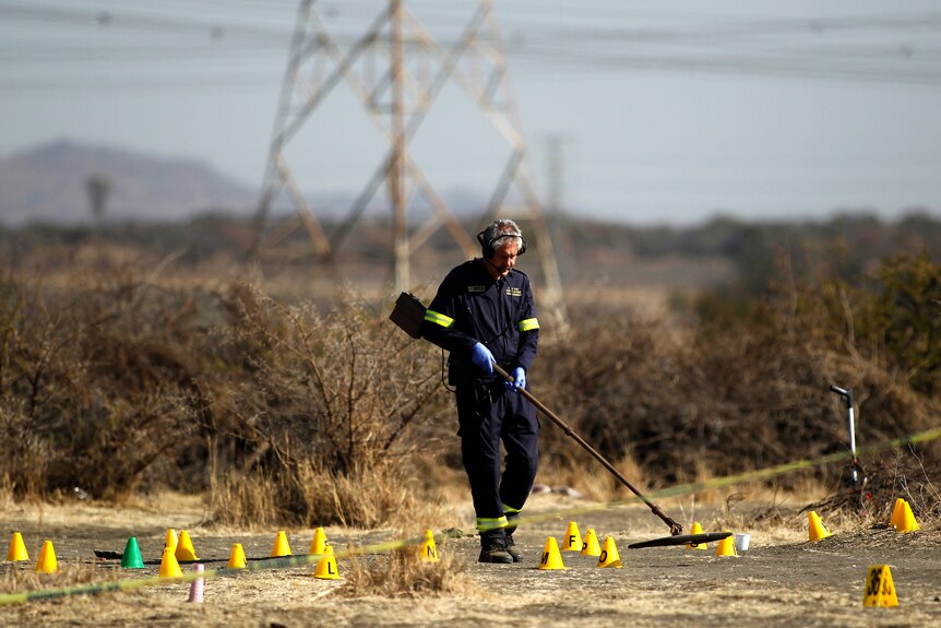 South African investigator at the scene where striking miners were shot