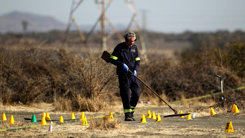 South African investigator at the scene where striking miners were shot
