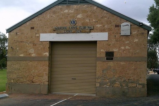 A stone building with a roller door and sign that says "Waikerie Lions Club".