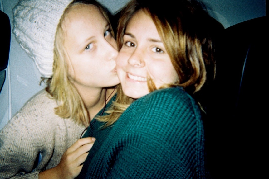 A 15-year-old Lily kisses Sarah's cheek.