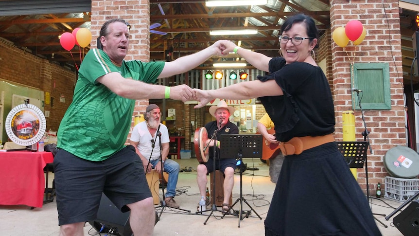 A couple dances in celebration after a long bushfire season at the St Albans community party.