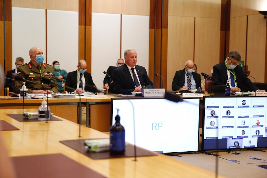 John Frewen, Richard Colbeck and Brendan Murphy sit alongside each other in a committee room