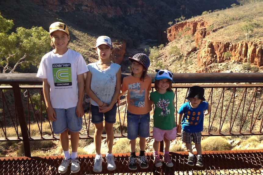 Kyra Cooney-Cross as a child stands with her four younger sisters outdoors in order of descending height.