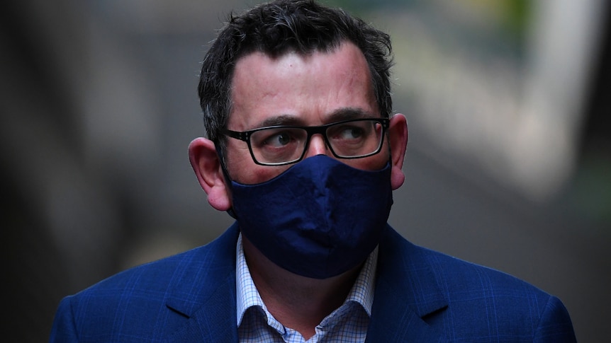 Victorian Premier Daniel Andrews wearing a face mask, arriving for a media conference.