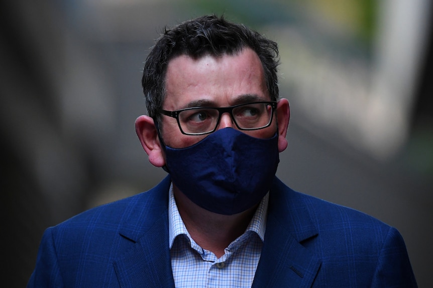 Victorian Premier Daniel Andrews wearing a face mask, arriving for a media conference.