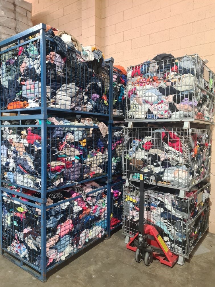 Metal containers holding piles of clothing