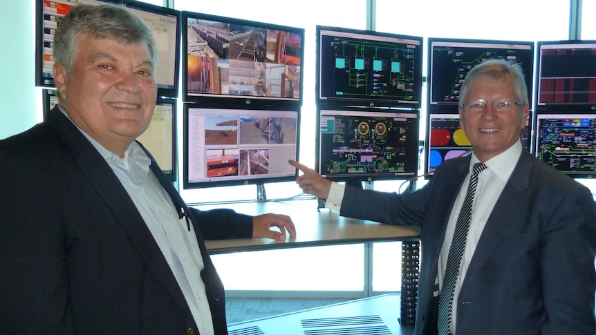 A global safety expert Daniel Roley with WA's Mines Minister Bill Marmion at BHP's automated centre in Perth