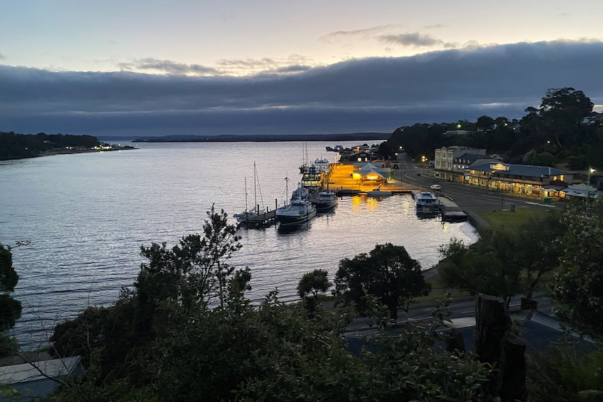 A harbour with boats at night time.